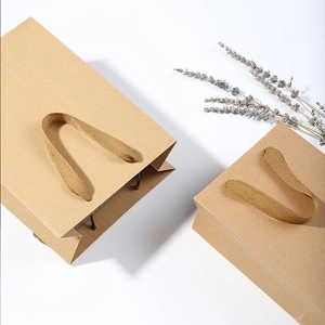 Vertical brown kraft paper gift bags with woven handles and lavender decoration