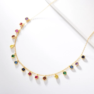 Macro shot of colorful round cubic zirconia pendant on golden s925 silver chain
