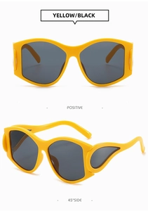 Detail of yellow punk sunglasses featuring unique wing-shaped cutout temples and dark lenses