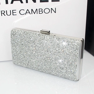 Detailed close-up of a luxury silver rhinestone evening clutch with elegant metal clasp