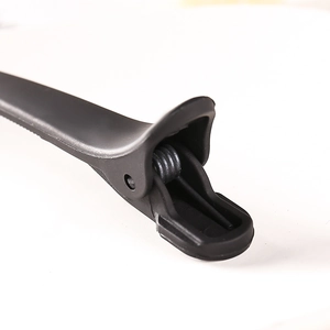 Macro detail of the matte black hair claw clip showing a durable metal spring hinge