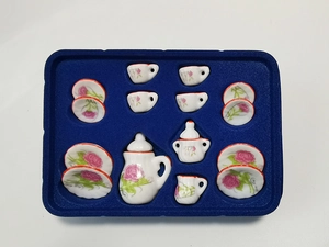 Detailed overhead view of 15-piece mini ceramic tea set with pink floral patterns