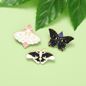 Three mystic moth and butterfly enamel pins set with moon and star celestial designs