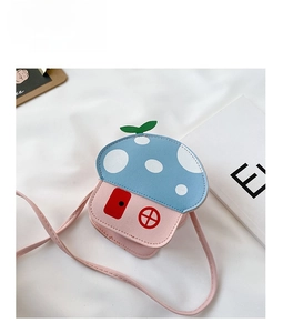 Close-up of mushroom house child crossbody bag with blue polka dot roof and pink base