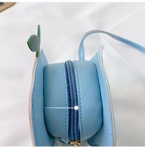 Detail shot of the smooth metal zipper on the blue mini mushroom crossbody bag
