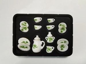 Detailed top view of 15-piece miniature white ceramic tea set with clover patterns