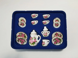 Detailed overhead view of 15-piece miniature ceramic dollhouse tea set with pink rose patterns
