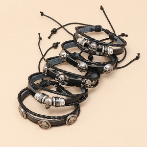 Set of five adjustable black braided leather bracelets with silver skull and ring charms