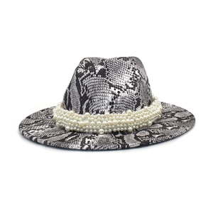 Macro detail of snakeskin fedora hat with elegant rows of staggered pearl band decoration