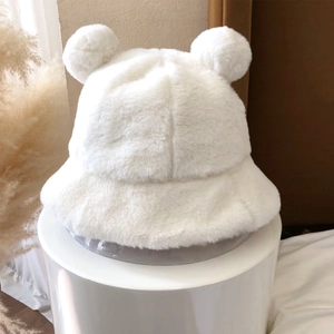 Detailed macro view showing plush white faux fur texture and cute bear ear design on hat
