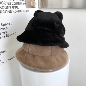 Detail of plush faux fur bucket hat featuring cute bear ears and thick warm texture