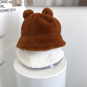 Detail view of plush faux fur bucket hats with cute bear ears in brown and cream white
