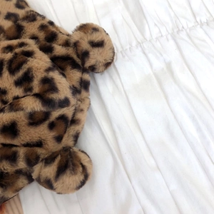 Macro shot of fluffy leopard print plush bucket hat featuring cute small round ears
