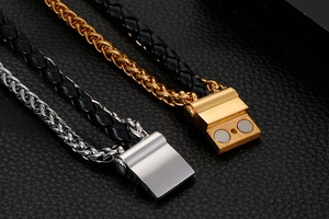 Macro detail of braided leather bracelets with gold and silver magnetic metal clasps