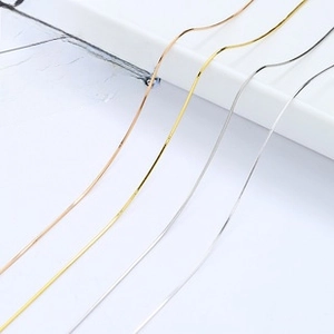 Detail view of four minimalist 925 sterling silver snake chains in various metal finishes