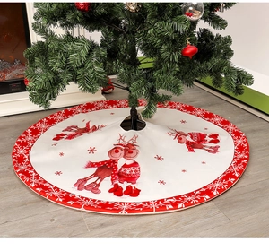 Close-up of a red Christmas tree skirt featuring white reindeer and snowflake prints