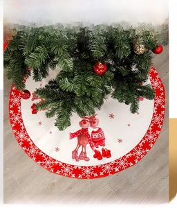 Detail of Christmas tree skirt featuring printed reindeer and snowflake patterns