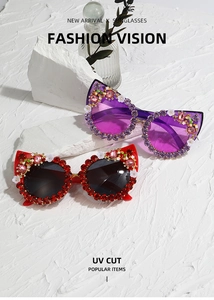 Detail view of cat eye sunglasses with rhinestones and floral accents with UV cut lenses