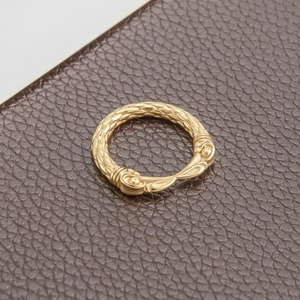 Detailed shot of vintage eagle beak ring with woven texture and gold finish
