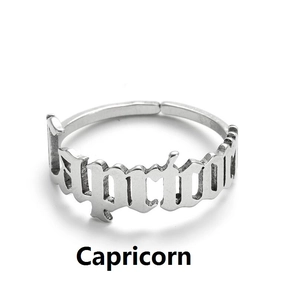 Macro detail of silver Capricorn gothic letter engraving on adjustable steel ring