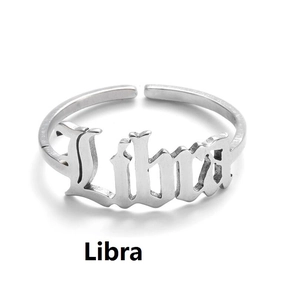 Detailed view of silver stainless steel Libra zodiac sign letter ring on white background