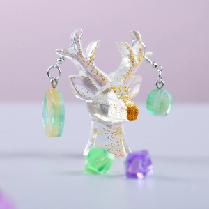 Detail of DIY antler stand and resin earrings with gold flakes and green gradient