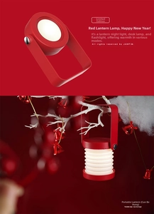 Macro detail of red folding lantern lamp showing expandable design and portable handle