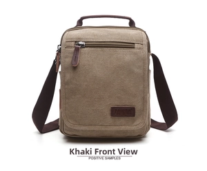 Detailed close-up of khaki canvas shoulder bag featuring brown strap and front zipper pocket