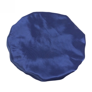 Close-up of dark blue satin sleep cap showing the smooth silk-like texture and elastic edge