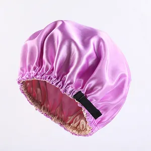 Light purple satin sleep bonnet with adjustable black elastic strap and silk lining