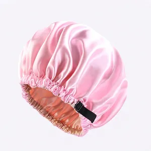 Detail of pink satin sleep bonnet showing the adjustable buckle and double-layer fabric