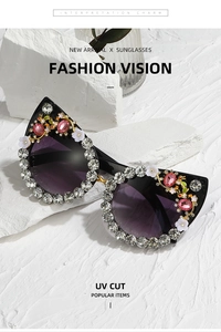 Detail of luxury cat-eye sunglasses with crystal rhinestones and floral accents