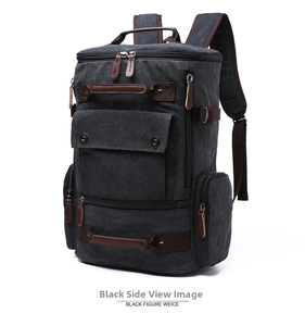 Detailed view of black canvas backpack featuring brown leather accents and multi-pocket design