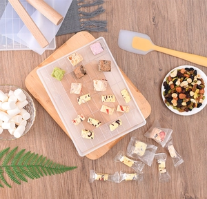 Top-down view of a 112-grid snowflake crisp mold with nougat ingredients and baking tools