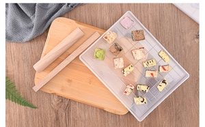 Close-up of snowflake crisp mold with wooden rolling pin and flat board for DIY baking
