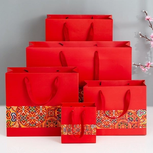 Detail of red festive gift bags in five sizes with traditional floral geometric patterns