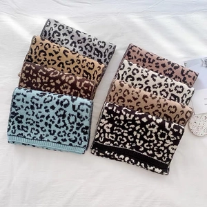 Thick leopard print knit scarves in various colors shown in a flat lay display