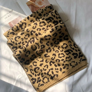 Detail of soft leopard print knitted scarf with ribbed edge and thick texture