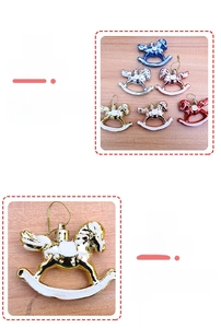 Detail view of electroplated rocking horse Christmas ornaments with white glitter dusting