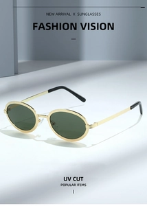 Macro detail of oval gold metal frame sunglasses with textured finish and UV cut lenses