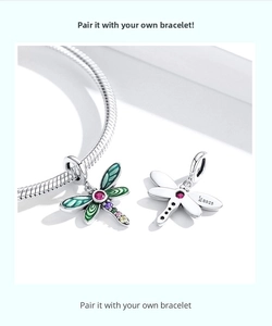 Macro detail of S925 sterling silver dragonfly charm with green enamel and colorful stones