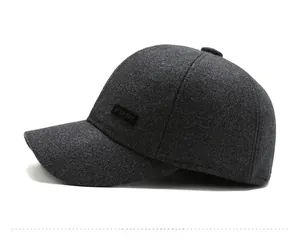 Detail view of dark grey wool baseball cap for men with sport label and warm ear flaps