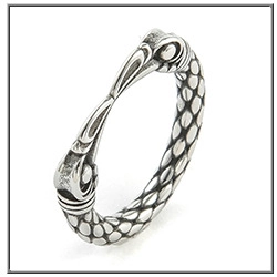 Detailed macro view of vintage viking ring with double bird heads and scale patterns
