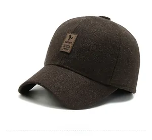 Close-up of brown wool texture and sport leather patch on a winter baseball cap