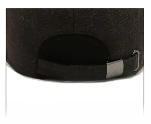 Detailed close-up of dark brown wool baseball cap with adjustable metal buckle at the back