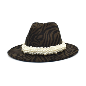 Close-up of zebra pattern wool jazz hat featuring elegant multi-layer pearl accessory
