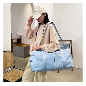 Close-up of a large light blue sports bag with durable nylon fabric and reinforced straps
