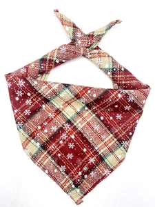 Close-up of red and green plaid cotton pet bandana with white snowflake patterns