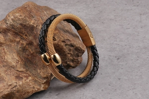 Detail of double-layer braided leather bracelet with gold metal mesh and magnetic clasp