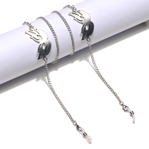 Detail of silver eyewear chain featuring punk wing charms and silicone anti-slip loops